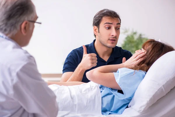 Молодий чоловік відвідує хвору дружину в клініці — стокове фото