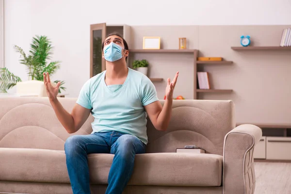 Young man sitting at home during pandemic — Stock Photo, Image