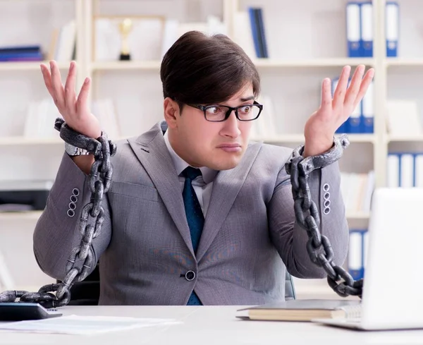 Businessman tied with chains to his work — Stock Photo, Image