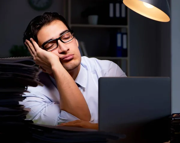 Joven hombre de negocios trabajando horas extras hasta tarde en el cargo — Foto de Stock