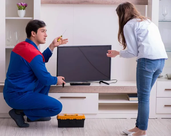 Tv repairman technician repairing tv at home