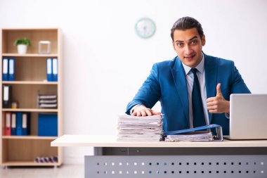 Genç işadamı ofiste oturuyor.