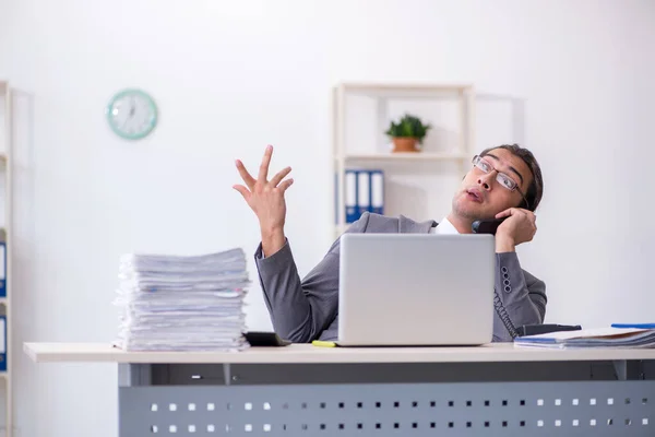 Giovane dipendente di sesso maschile che parla per telefono in ufficio — Foto Stock