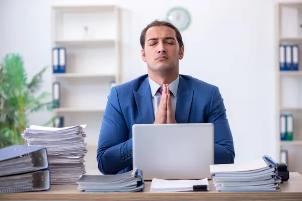 Young male bookkeeper unhappy with excessive work in the office — ストック写真