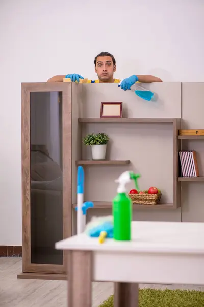 Young male contractor cleaning the house — Stock Photo, Image