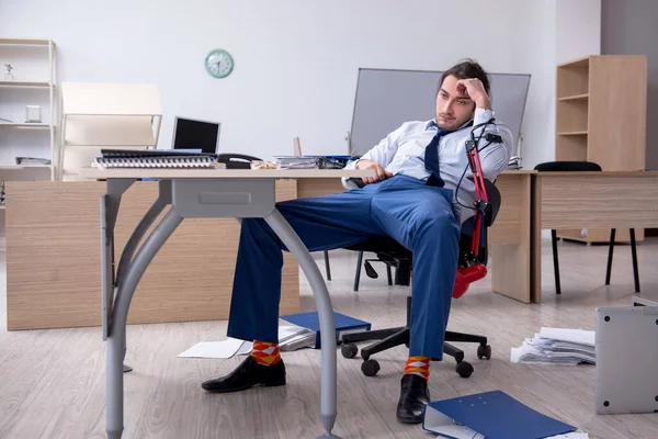 Young male employee unhappy with excessive work — Stock Photo, Image