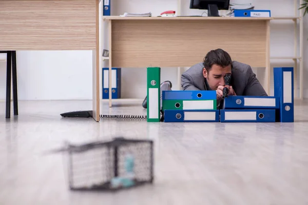 Young male employee and mousetrap in the office — Stock Photo, Image