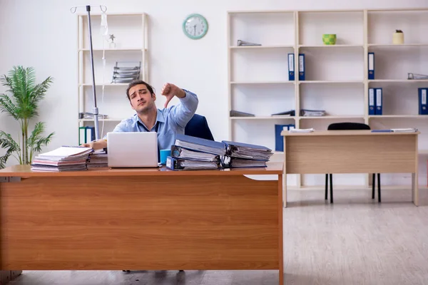 Young male employee suffering at workplace — Stock Photo, Image