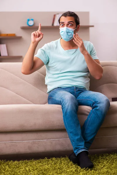 Young man sitting at home during pandemic — Stock Photo, Image