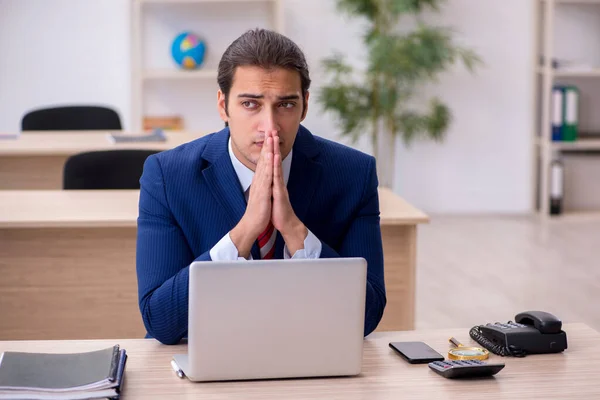 Joven empleado masculino sentado en la oficina — Foto de Stock