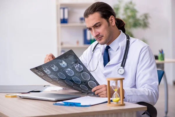 Young male doctor in time management concept — Stock Photo, Image