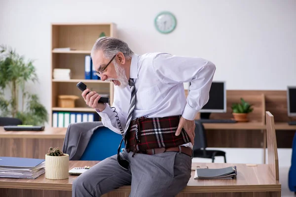 Gammal manlig anställd som lider av radikulit på arbetsplatsen — Stockfoto