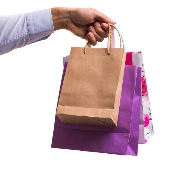 Hand holding shopping bags with christmas shopping on white back — Stock Photo, Image