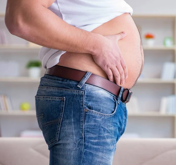 Man suffering from extra weight in diet concept — Stock Photo, Image