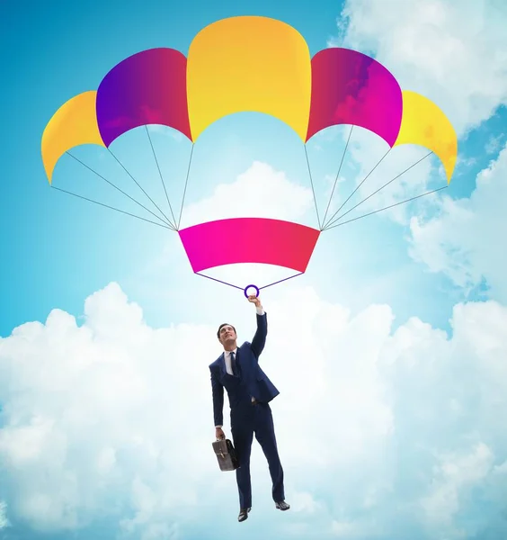 Jovem empresário caindo em paraquedas no conceito de negócio — Fotografia de Stock