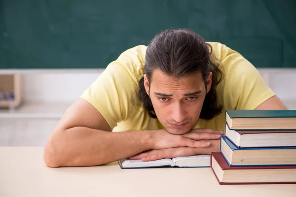 Young male student preparing for exams in the classroom — Stock Photo, Image