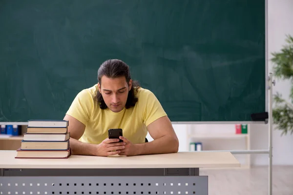 Young male student preparing for exams in the classroom — Stock Photo, Image