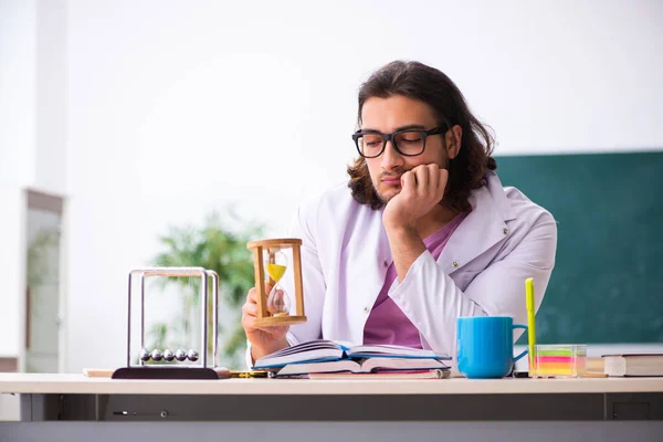 Junge männliche Physiklehrerin im Zeitmanagement-Konzept — Stockfoto