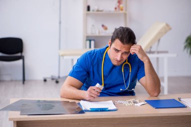 Genç erkek hasta doktor gece vardiyasından sonra mutsuz oluyor.