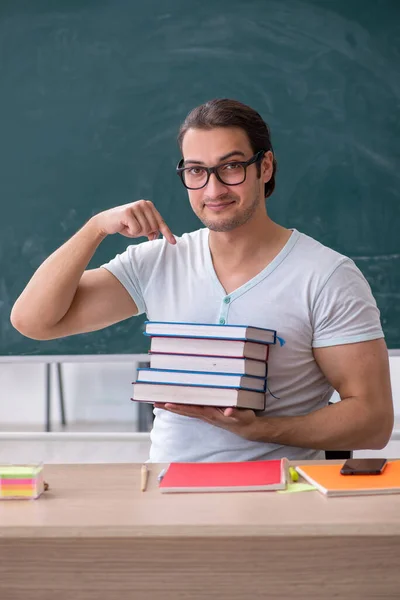 Young male teacher student sitting in the classroom — Stock Photo, Image