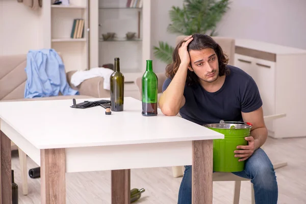 Young alcohol addicted man suffering from stomachache at home — Stock Photo, Image