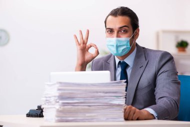 Salgın sırasında maske takan genç bir erkek.