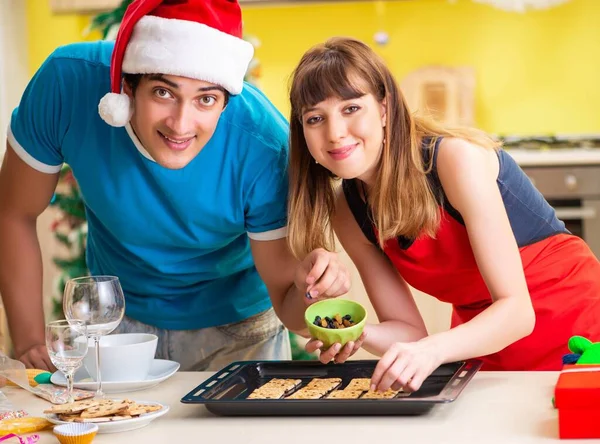 Young couple celebrating Christmas in kitchen — Stock Photo, Image