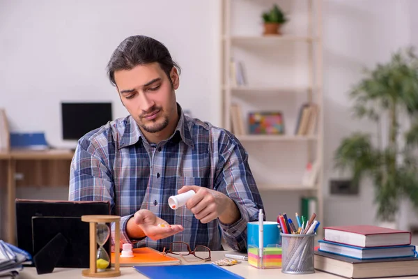 Jonge mannelijke student zit in de klas — Stockfoto