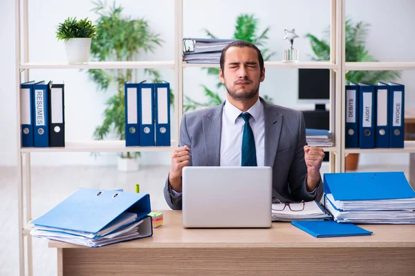 Jeune employé masculin et trop de travail au bureau — Photo