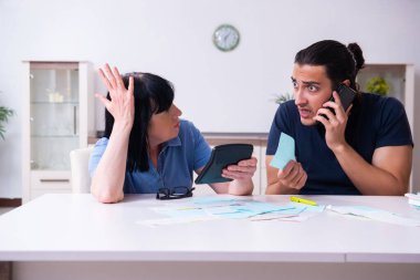 Kadın emekli ve genç oğlu bütçe planlama konseptinde.