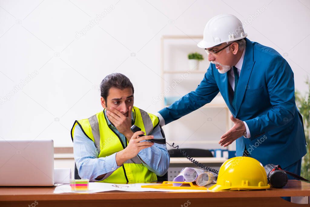 Two male architects working in the office