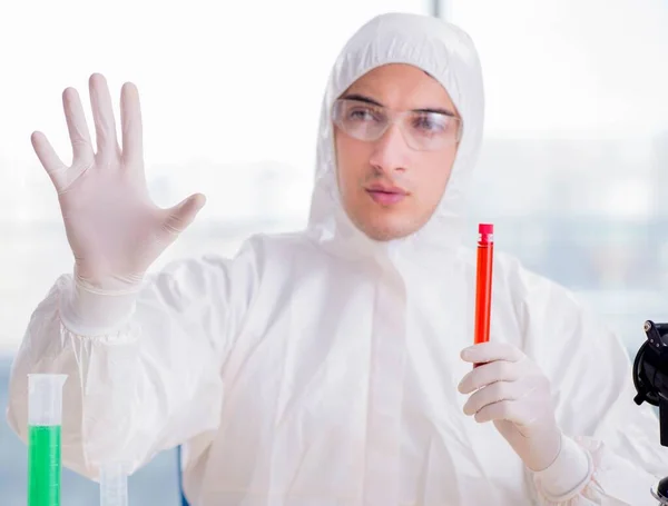 Young chemist pressing virtual buttons in lab — Stock Photo, Image