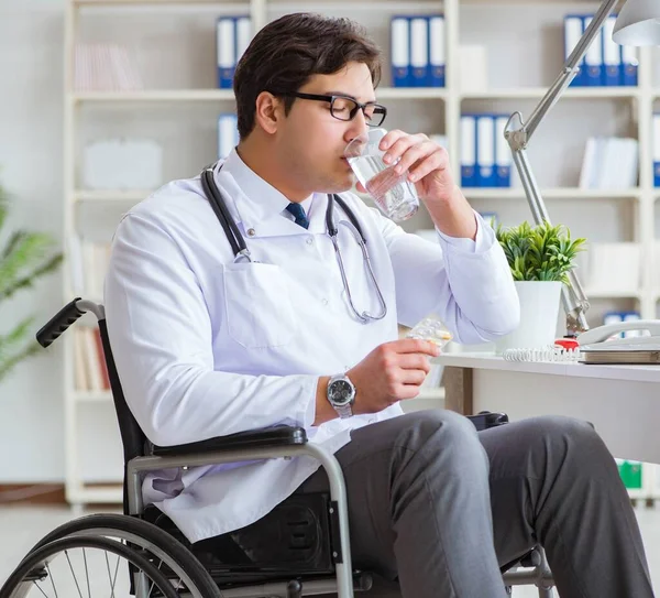 Disabled doctor on wheelchair working in hospital