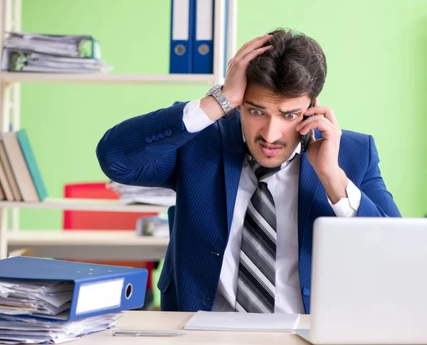 Zakenman ongelukkig met buitensporig werk op kantoor — Stockfoto