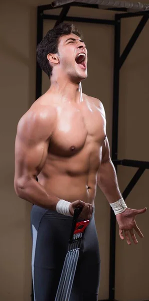 Man working in the gym with springs — Stock Photo, Image