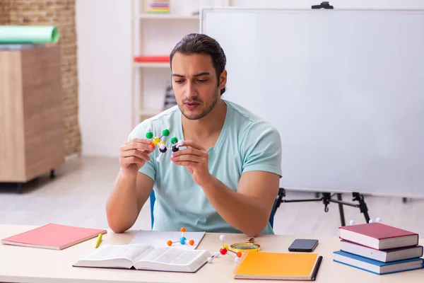 Young male student physicist studying molecular model at home — Stock Photo, Image