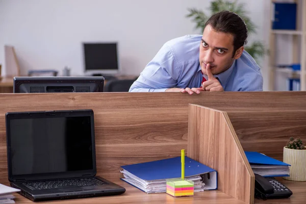 Young male employee in industrial espionage concept — Stock Photo, Image