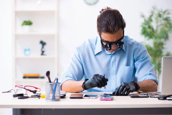 Jeune technicien masculin réparer téléphone mobile — Photo