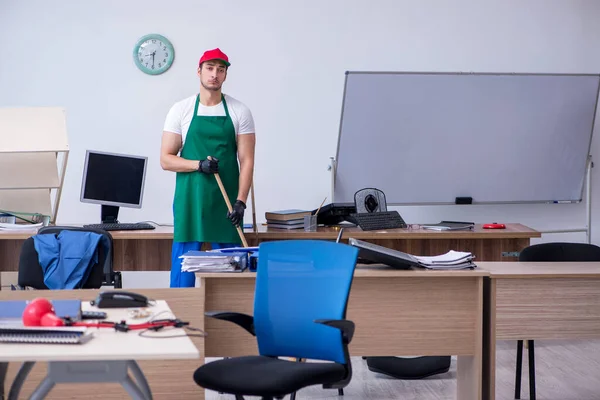 Young male contractor cleaning the office — Stock Photo, Image