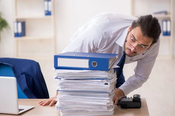 Young businessman unhappy with excessive work in the office — Stock Photo, Image