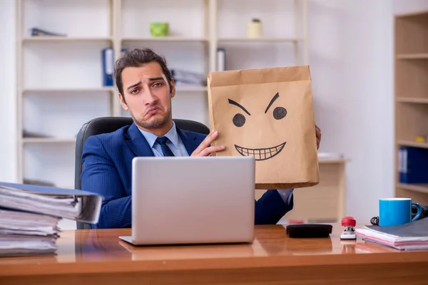 Young male employee with box instead of his head — Stock Photo, Image
