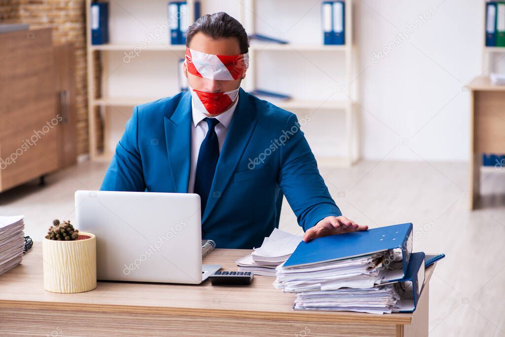 Mouth and eyes closed male employee working in the office