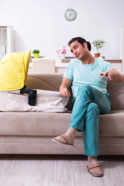 Genç erkek ebeveyn yeni doğan bebeğe evde bakıyor.