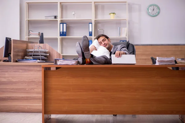Joven empleado masculino durmiendo en el lugar de trabajo —  Fotos de Stock
