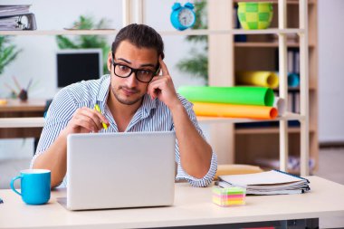 Ofiste çalışan genç bir erkek.