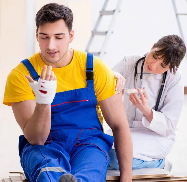 Injured worker being assisted by doctor