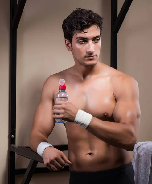 Spragniony człowiek pijący wodę w siłowni sportowej — Zdjęcie stockowe