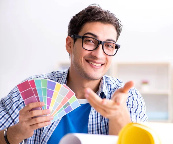 Young designer working on new project and choosing colours Royalty Free Stock Photos