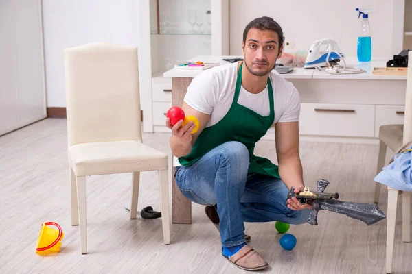 Genç erkek müteahhit çocuk partisinden sonra daireyi temizliyor. — Stok fotoğraf