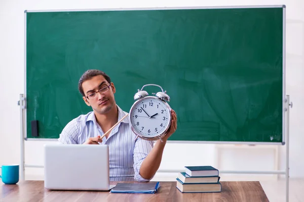 Young male teacher in time management concept — Stock Photo, Image